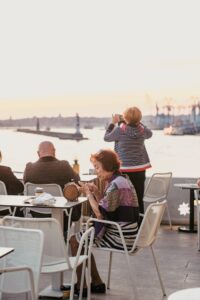 Enjoying a relaxing view over the sea at a seaside restaurant terrace during sunset.