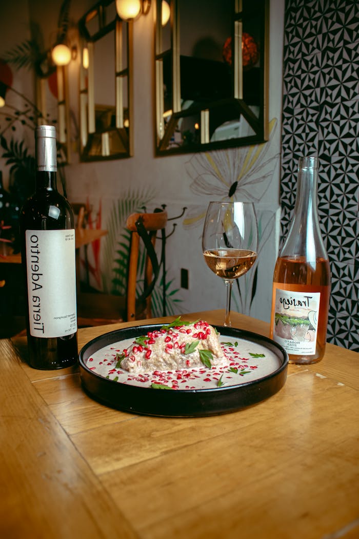 Stylish restaurant scene with gourmet dish, wine, and chic décor.